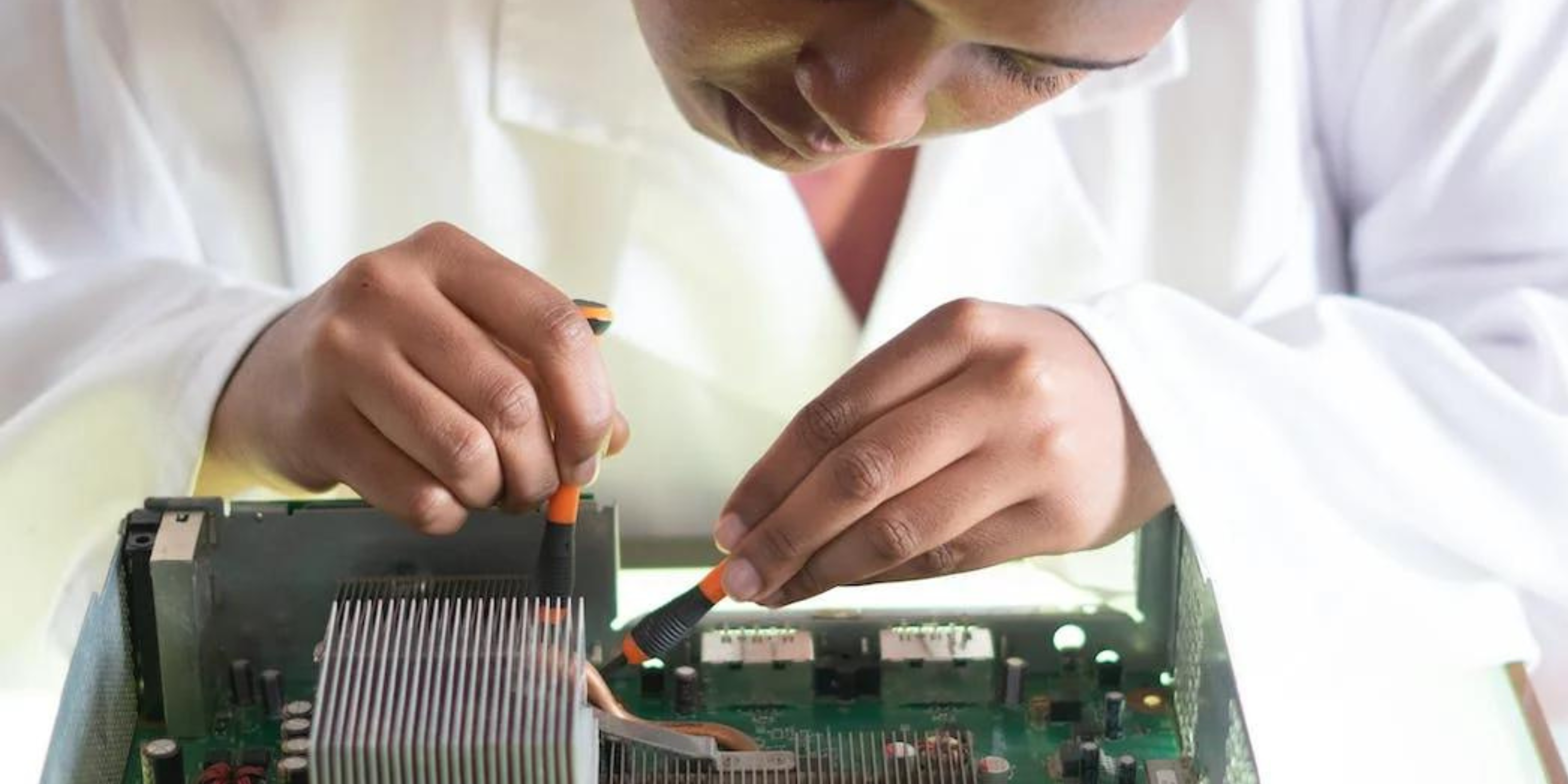 person fixing electronic board